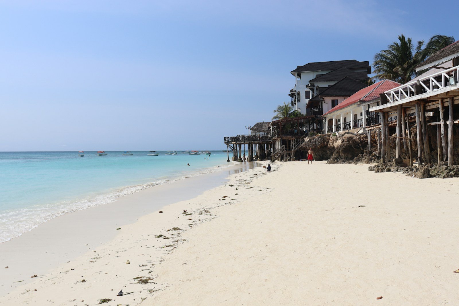 A white sandy beach with houses on it