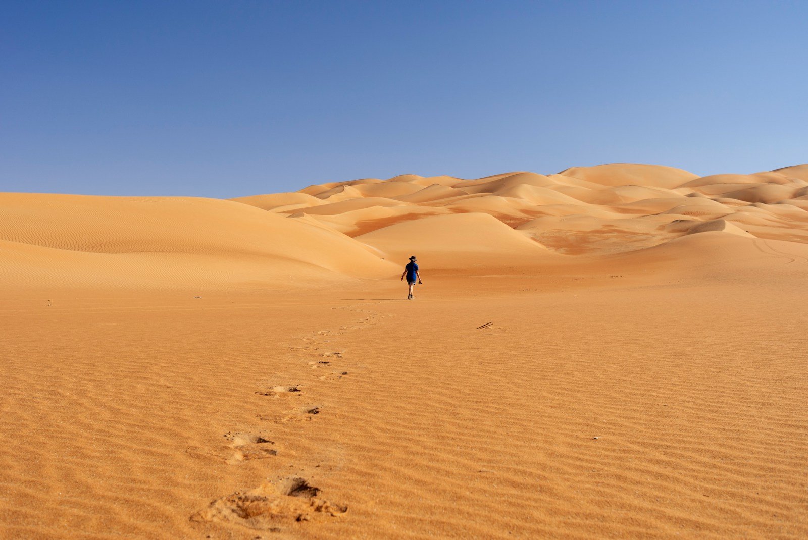 person walking on desert during daytime