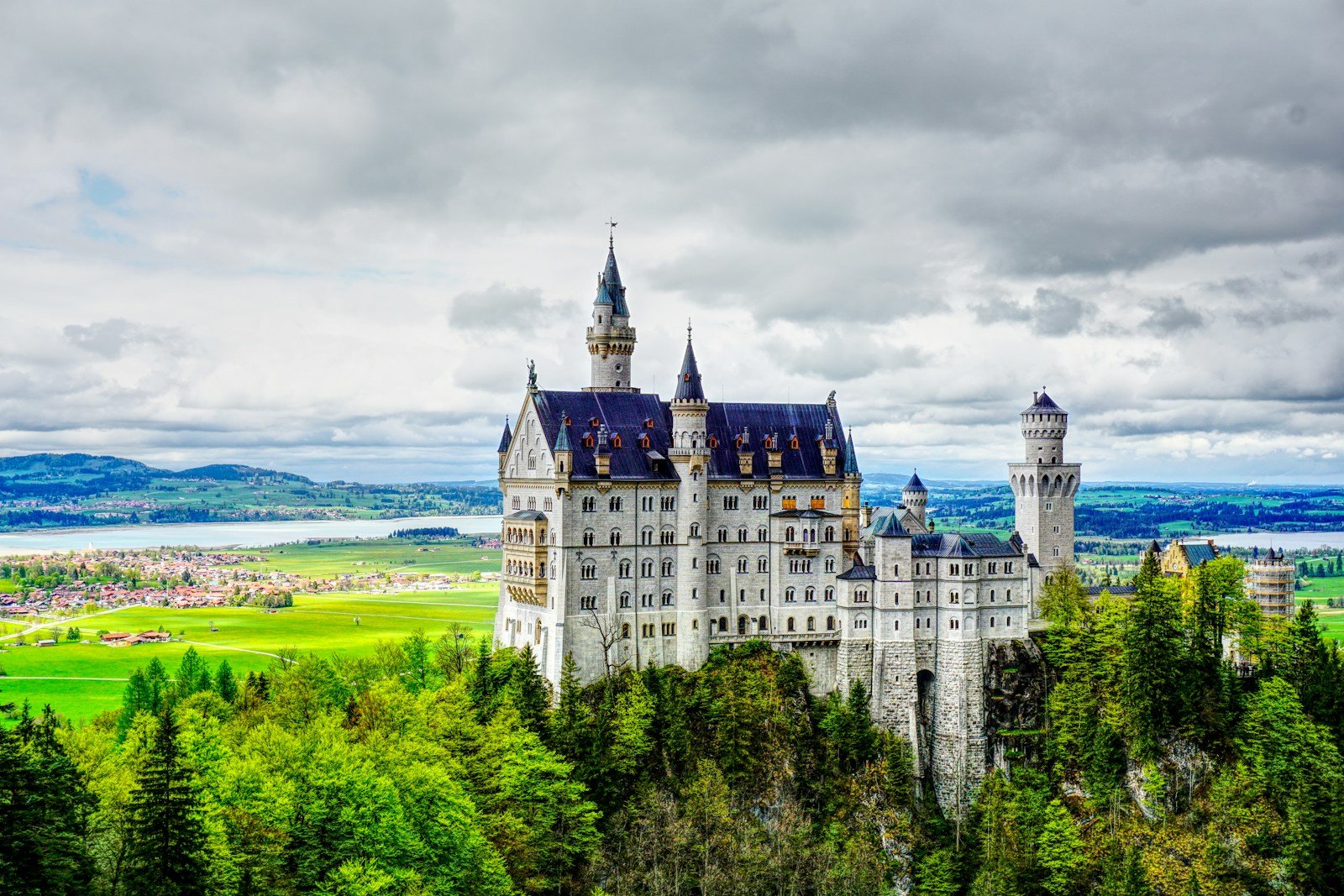 white and blue castle under gray clouds