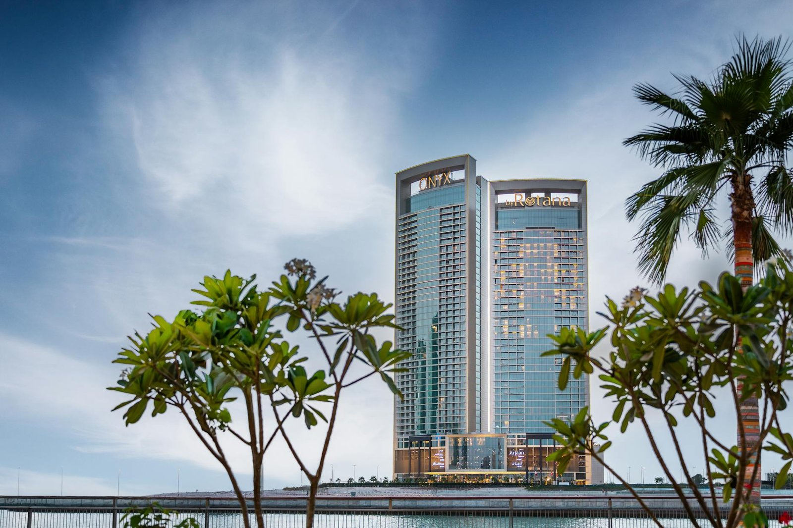 A breathtaking view of Manama's skyline with prominent towers against a vibrant sky.