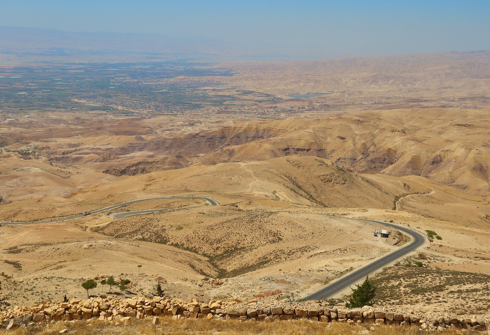 a car driving down a road in the middle of the desert